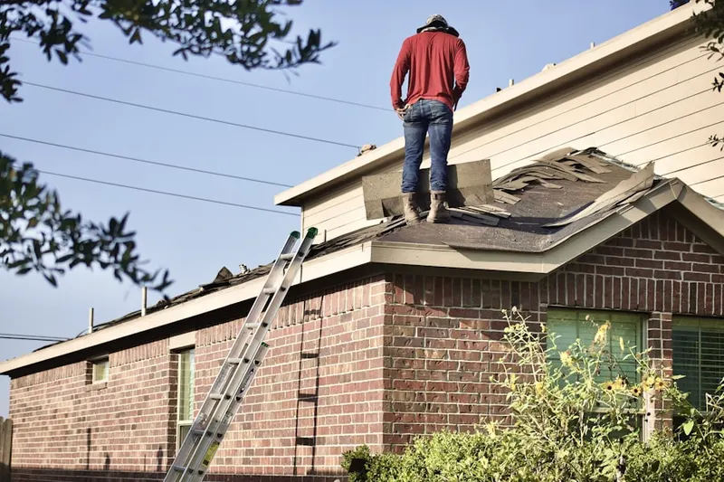 Professional roofer working on a residential roof in Merrillville